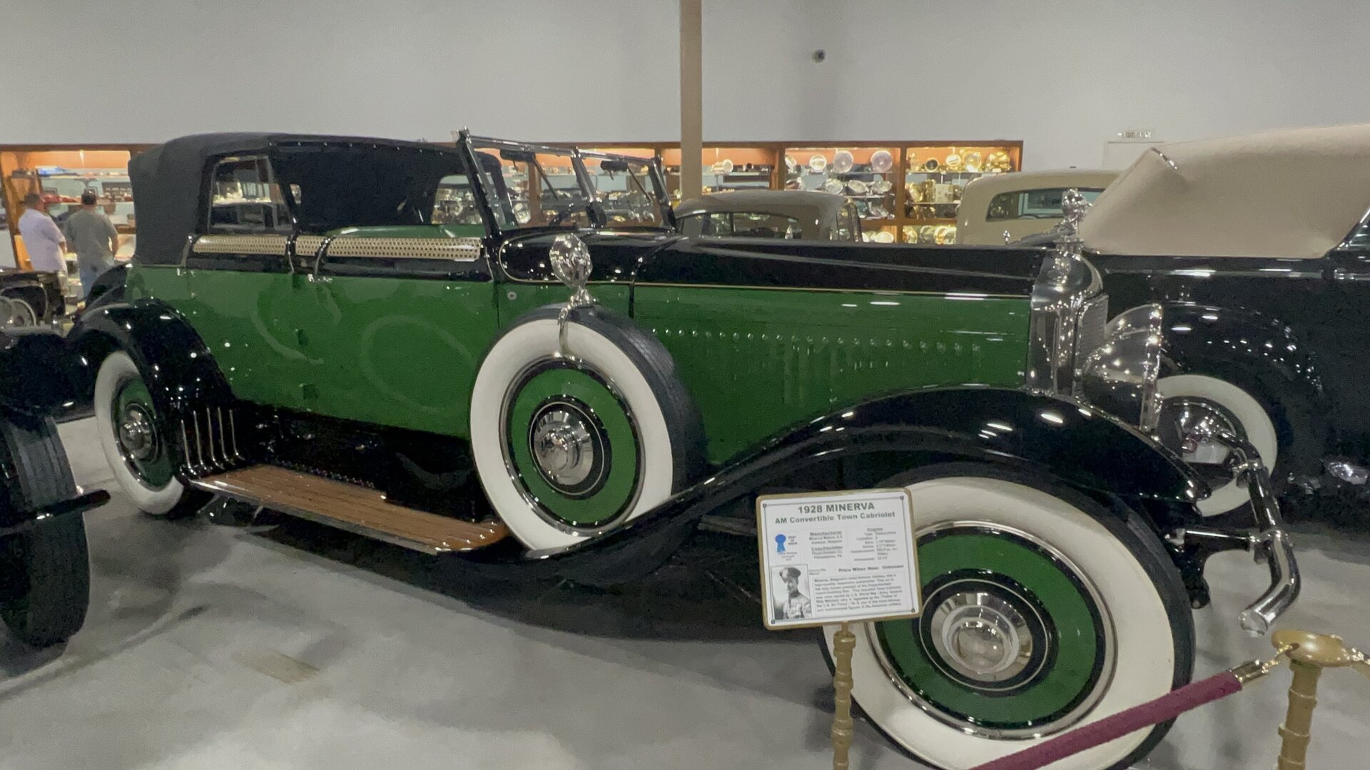 A 1928 Minerva Type AM Convertible Town Cabriolet at the Nethercutt Museum, green and black paintwork, woven cane detailing along the shoulder, coachwork by Floyd-Derham of Philadelphia.
